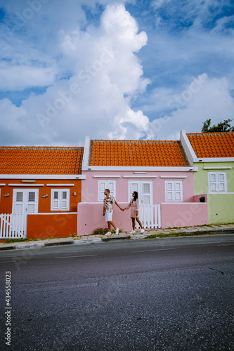 Curacao, colorful bouldings around Willemstad Punda and Otrobanda Pietermaai district, multicolored homes in Pietermaai Curacao Caribean Island , couple men and woman on vacation Curacao photo