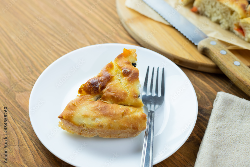 Focaccia, an Italian ready-to-eat dish surrounded by kitchen accessories Focaccia, an Italian ready-to-eat dish surrounded by kitchen accessories