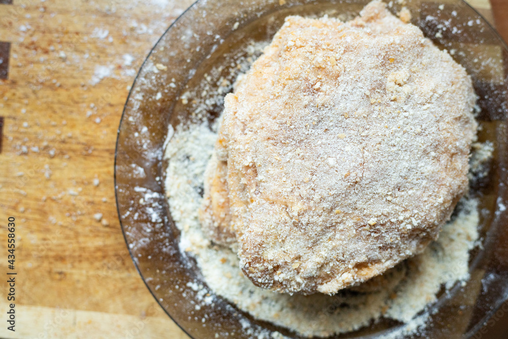 Breaded pork chop lying on a plate. Traditional dinner. Breaded pork chop lying on a plate. Traditional dinner.