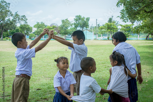 Surin, THAILAND - October 15, 2020:Thai students  are playing traditional Thai game, Catching the last one in the line traditional at a local  school field 