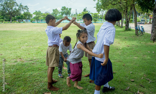 Surin, THAILAND - October 15, 2020:Thai students  are playing traditional Thai game, Catching the last one in the line traditional at a local  school field "Ri Ri Khao San"