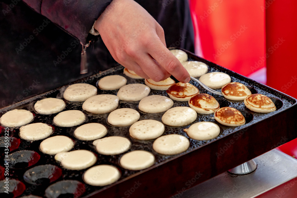 Making fresh poffertjes (Traditional Dutch batter treat) Resembling small fluffy pancakes they are made with yeast and buckwheat flour, Poffertjes are popular in the Netherlands.