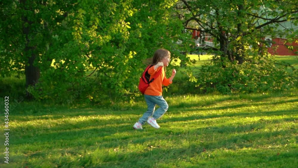 Camera movement on happy preschooler with school backpack runs and laughs in green summer park. Back view of little child girl fun rests after primary school. Outdoors Camera movement on happy preschooler with school backpack runs and laughs in green summer park. Back view of little child girl fun rests after primary school. Outdoors