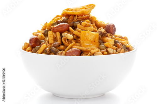 Close up of spicy Ratlami mixture Indian namkeen (snacks) on a ceramic white bowl.