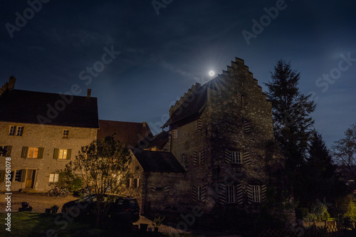 Castle with super moon at night. Youth hostel Altenburg in Brugg, 27. April 2021. Vertical shot.