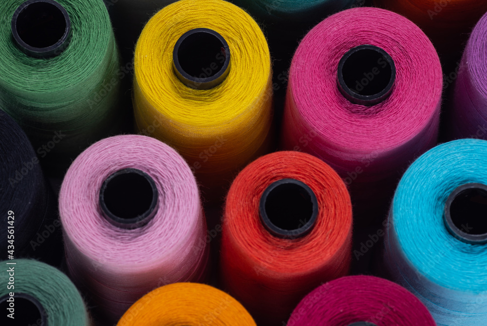 Spools of colored thread. View from above. Sewing and needlework concept. Spools of colored thread. View from above. Sewing and needlework concept.
