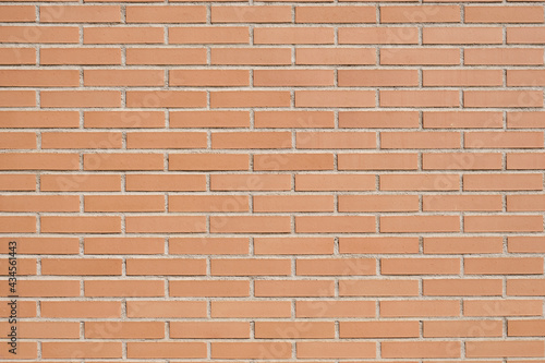 Brick wall with clean orange bricks. Background horizontal texture.