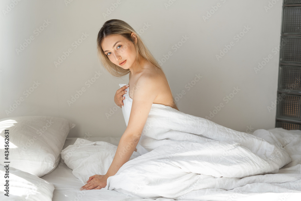 beautiful young woman in the bedroom with white blanket beautiful young woman in the bedroom with white blanket