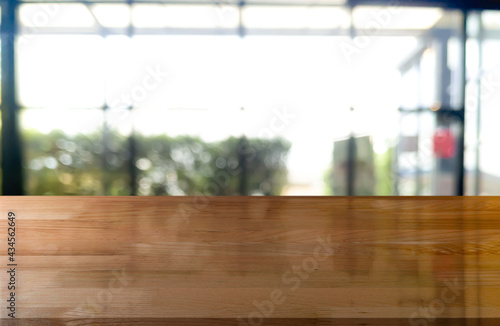 Fototapeta Naklejka Na Ścianę i Meble -  Empty wooden table top with lights bokeh on blur restaurant background.