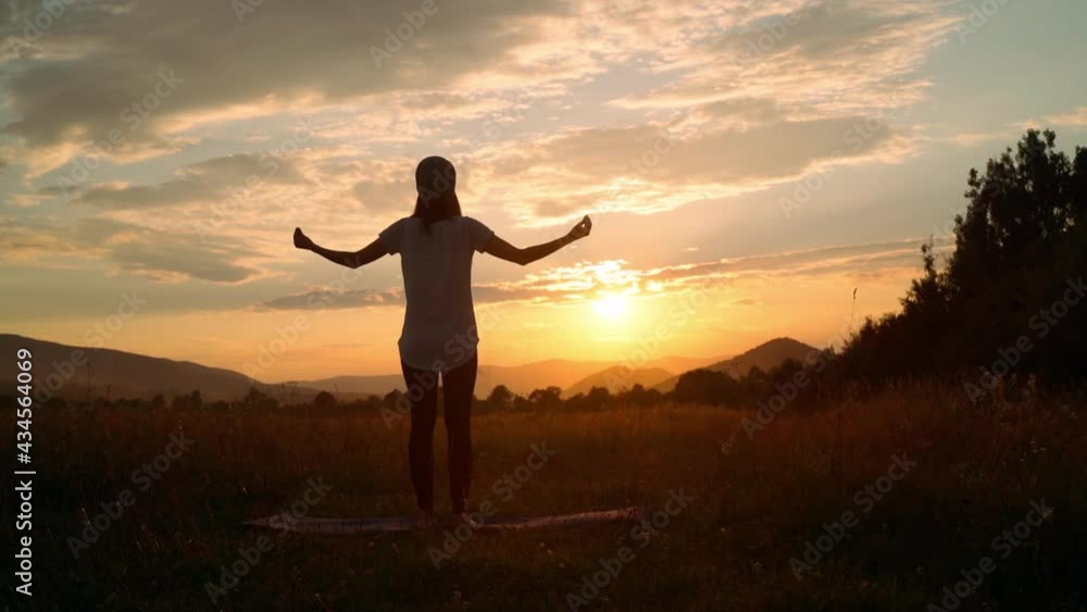 female meditating on meadow mountain landscape in sun rays slow motion healthy and wellness lifestyle female meditating on meadow mountain landscape in sun rays slow motion healthy and wellness lifestyle