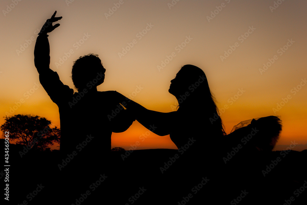 silhouette performing ballet dancer at the sunset. women  and man couple 