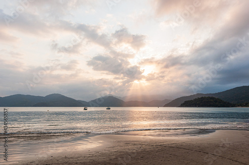 Colorful sunset view in dusk beach tropical summer climate with mountains in the background