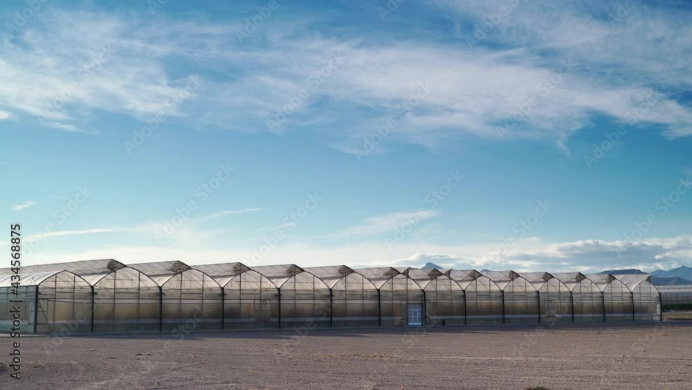 Time lapse of clouds moving over spanish coast landscape with big commercial glass greenhouses. Industrial agriculture. Murcia region, Spain. Time lapse of clouds moving over spanish coast landscape with big commercial glass greenhouses. Industrial agriculture. Murcia region, Spain.