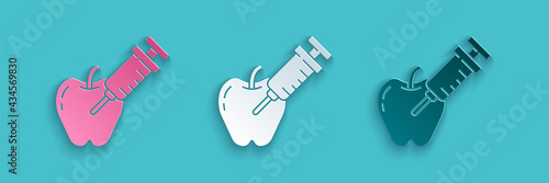Paper cut Genetically modified apple icon isolated on blue background. GMO fruit. Syringe being injected to apple. Paper art style. Vector