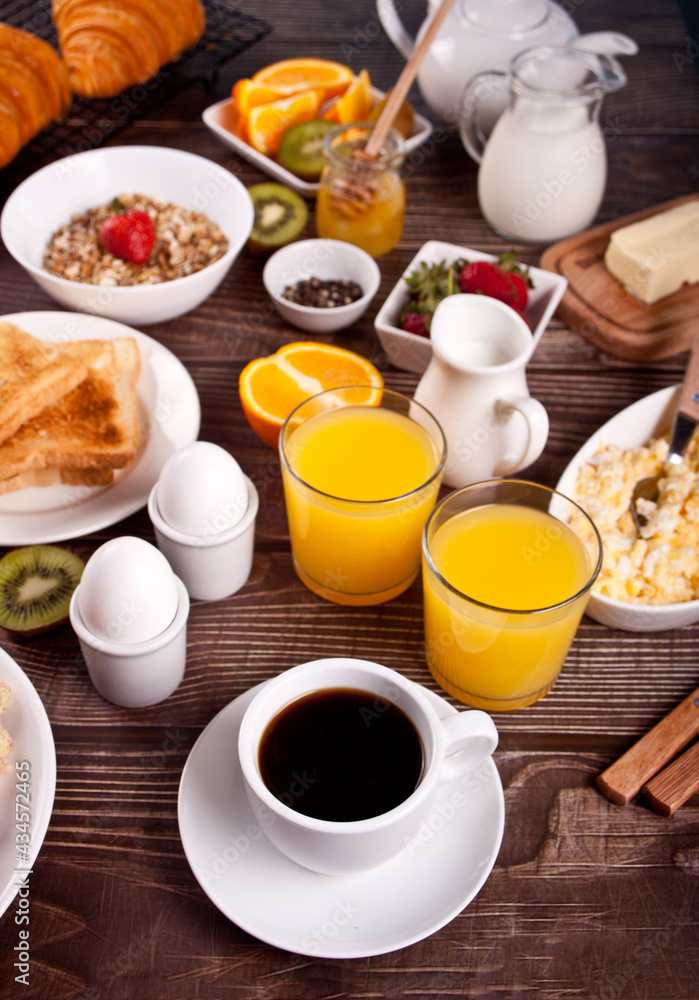 Cup of coffee, juice, eggs, fruits, toasts. Breakfast concept. Cup of coffee, juice, eggs, fruits, toasts. Breakfast concept.