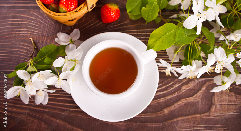 Cup of tea with white apple blossoms. Spring concept.