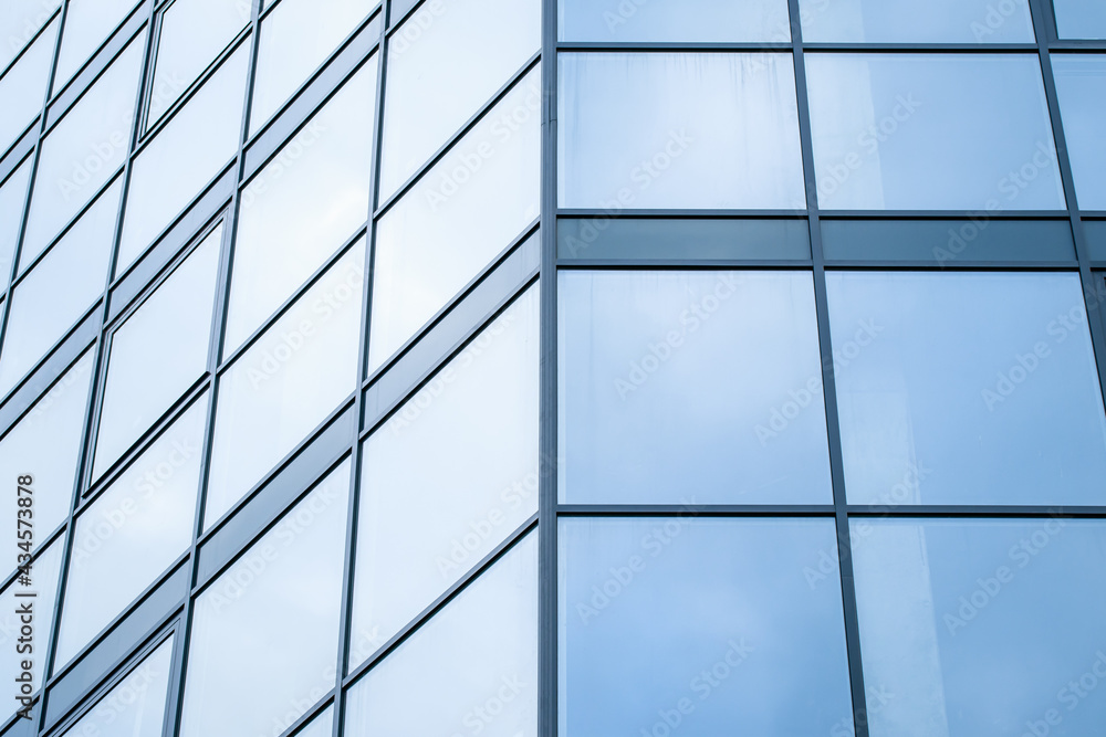 Blue glass wall of skyscraper, modern building, windows texture. Geometric abstract pattern. Architectural steel surface, background. Fragment of urban metal reflection structure. Business center. Blue glass wall of skyscraper, modern building, windows texture. Geometric abstract pattern. Architectural steel surface, background. Fragment of urban metal reflection structure. Business center.