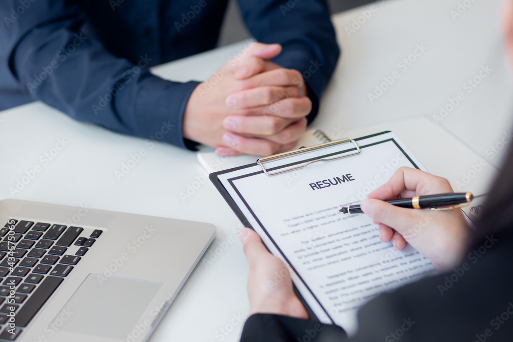 Male employer holding resume talking with female job candidate at interview, black millennial girl recruitment process, speak with HR Male employer holding resume talking with female job candidate at interview, black millennial girl recruitment process, speak with HR
