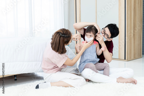 Asian parents wear masks for daughters with developmental disabilities. Before preparing to leave the house to prevent PM2.5 and Covid-19 dust, medical commentary.