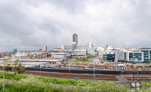 Sheffield City Centre UK Panoramic wide angle view of the whole steel city with railway station and university campus under dramatic sky. Modern skyline viewpoint of big new city architecture.