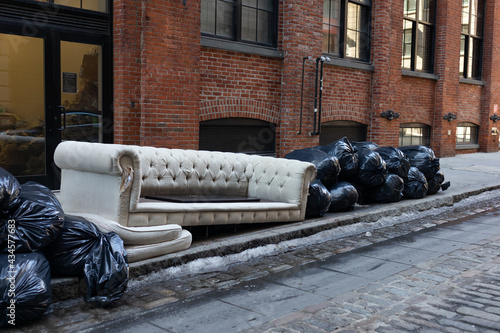 Photography Old Couch and Trash Bags along a Street in Dumbo Brooklyn of New York City