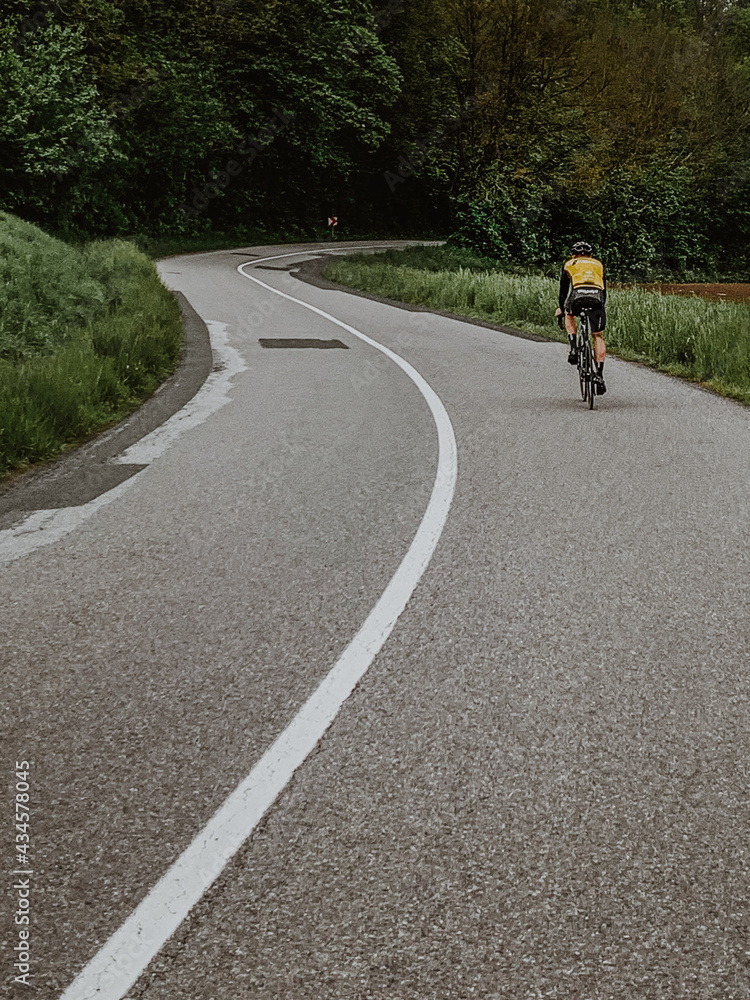 Obraz premium Cyclist riding along a road. Road cycling.