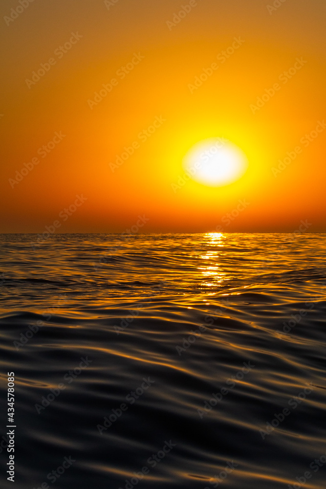 summer sunset on the background of sea waves
