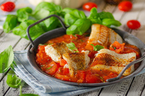 Delicious grilled fish with tomato sauce