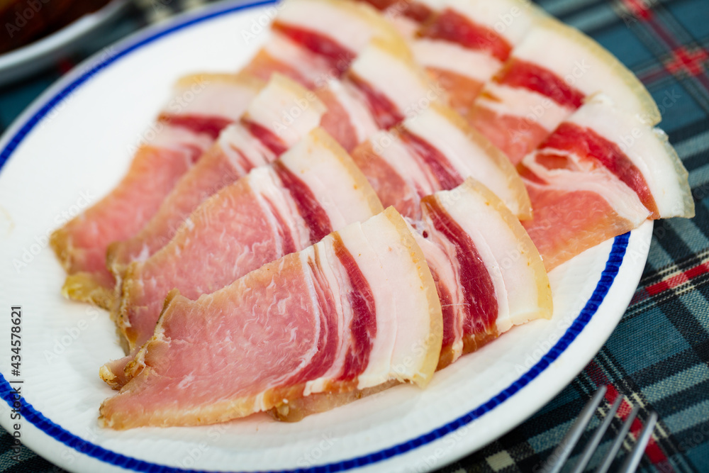 Close-up on a thin slices of fresh bacon in a restaurant