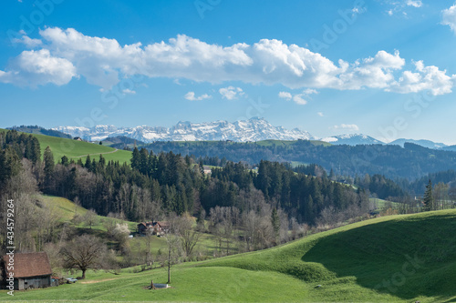 View over the hills of Appenzell towards snow-covered mount Saentis, Switzerland