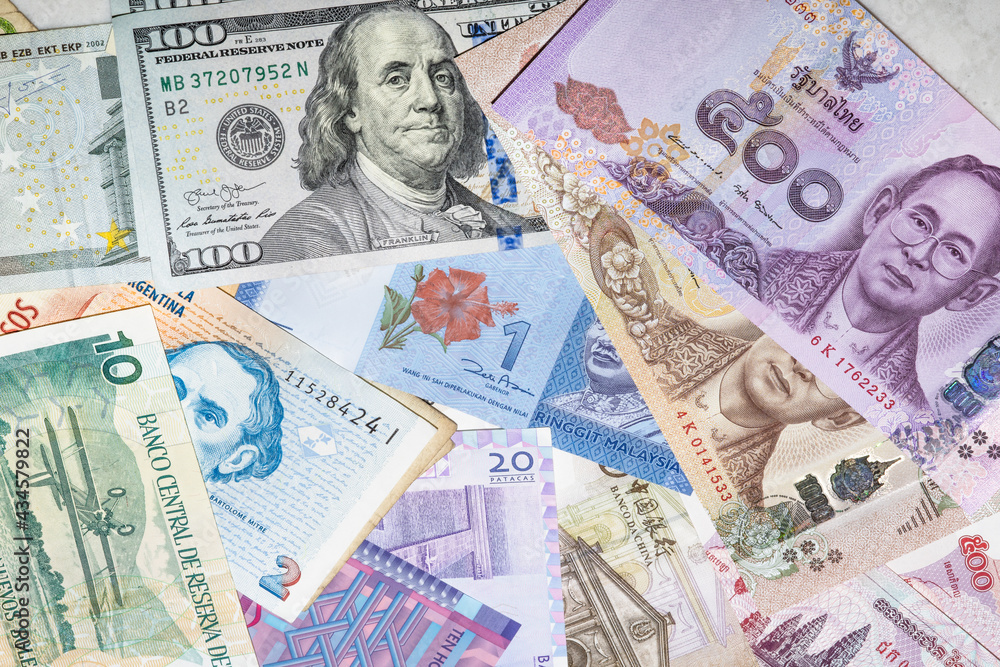 Heap of different foreign currency banknotes for travel in many countries (USD, Euro, Southeast Asia cash collection). International money investment, global financial trade market. World economic