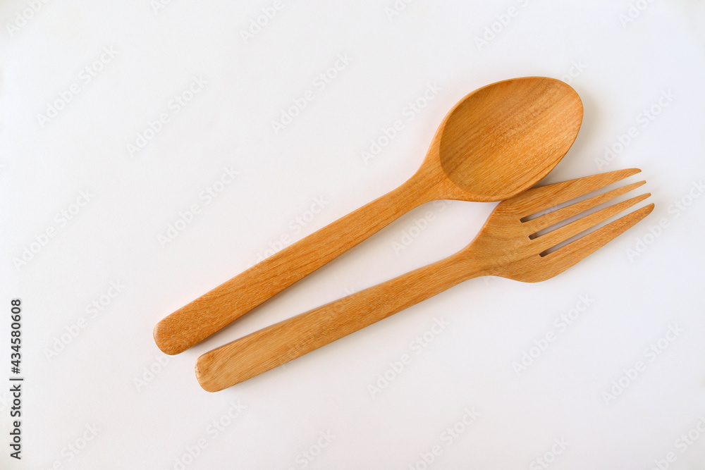 Spoon and fork wooden, kitchenware isolated on white background closeup. Spoon and fork wooden, kitchenware isolated on white background closeup.