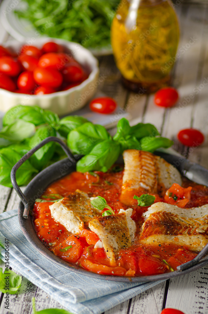 Delicious grilled fish with tomato sauce
