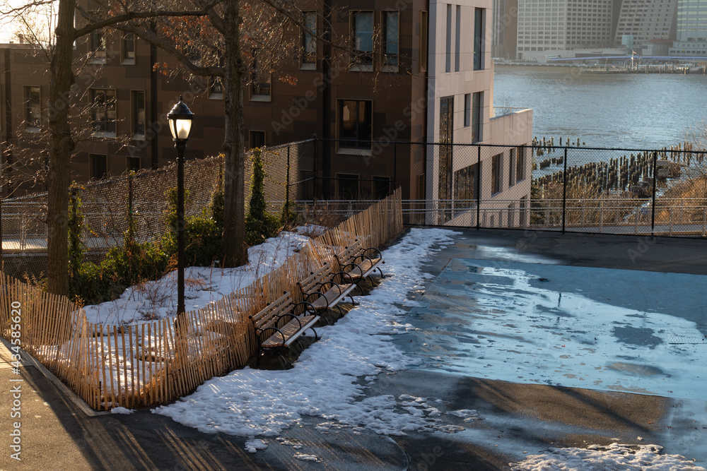 Empty Park with Melting Snow and Benches in Brooklyn Heights of Brooklyn New York