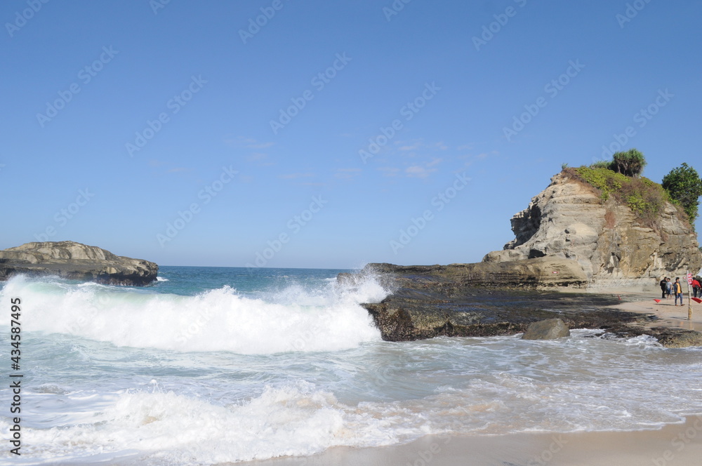 Beautiful scenery of extreme waves with blue skies on Klayar Beach, Pacitan Indonesia
