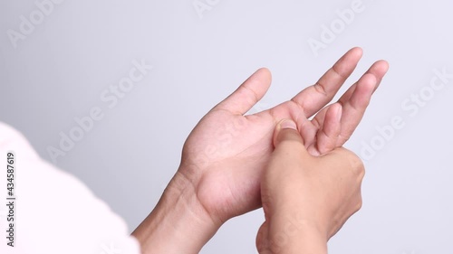 Close up young Asian women suffering pain in hand around finger joint and using the thumb to massage, exercise, treatment her painful. Concept of Office syndrome, Neuropathy, hand pain, Healthy Care.