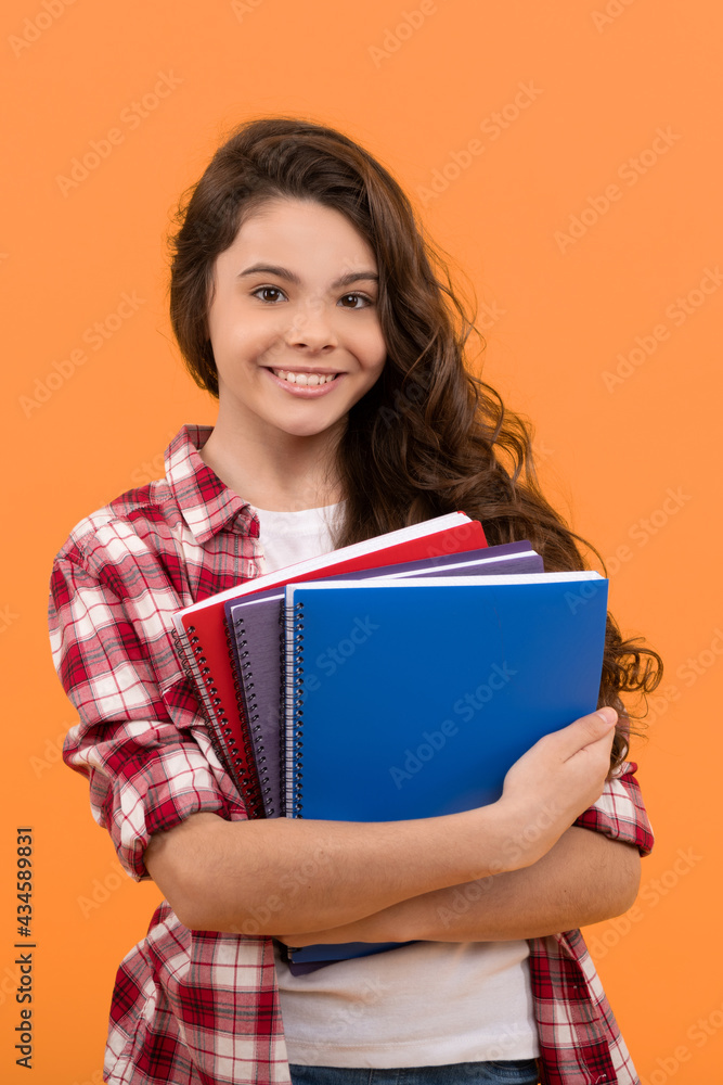 cheerful kid going to do homework with books. smiling student. education and knowledge. cheerful kid going to do homework with books. smiling student. education and knowledge.