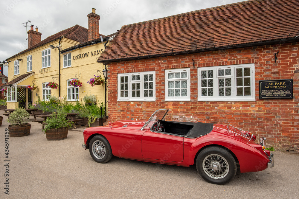 Classic vintage MG sports car parked at a traditional English pub, The