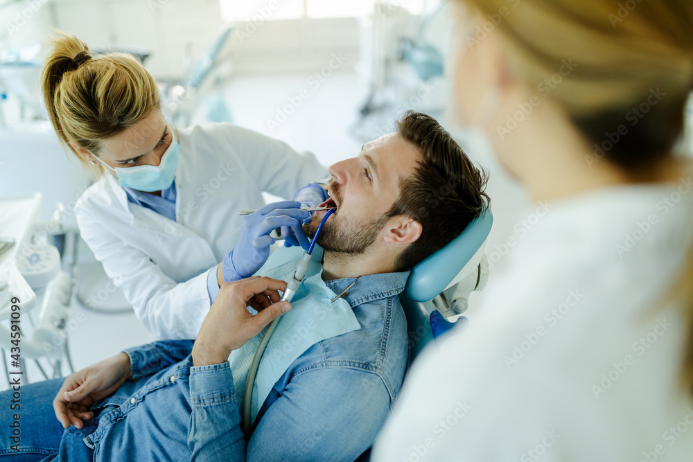 Man having teeth examined at dentists.