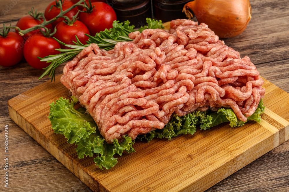 Raw pork minced meat over board Raw pork minced meat over board