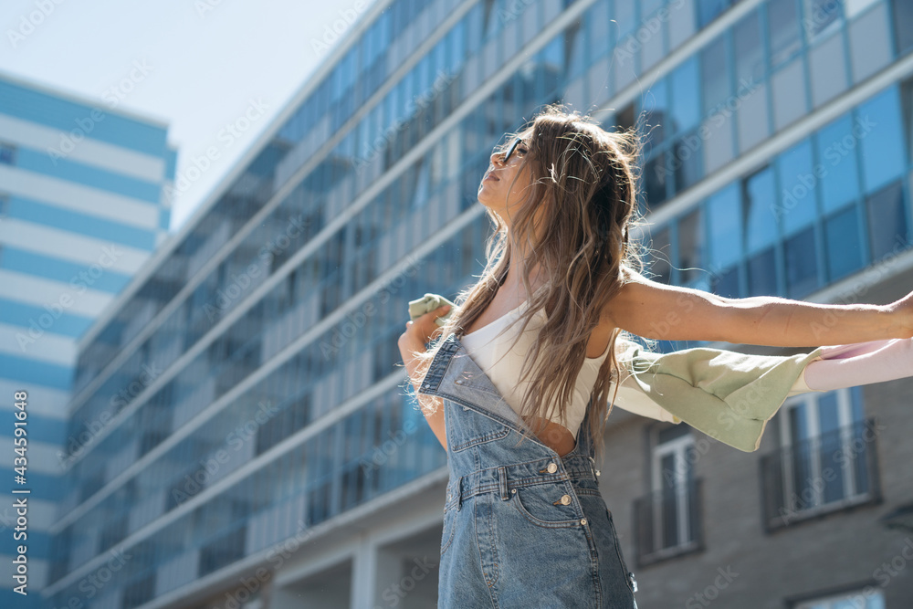 Fototapeta premium Attractive happy young woman with flying hair enjoying her free time