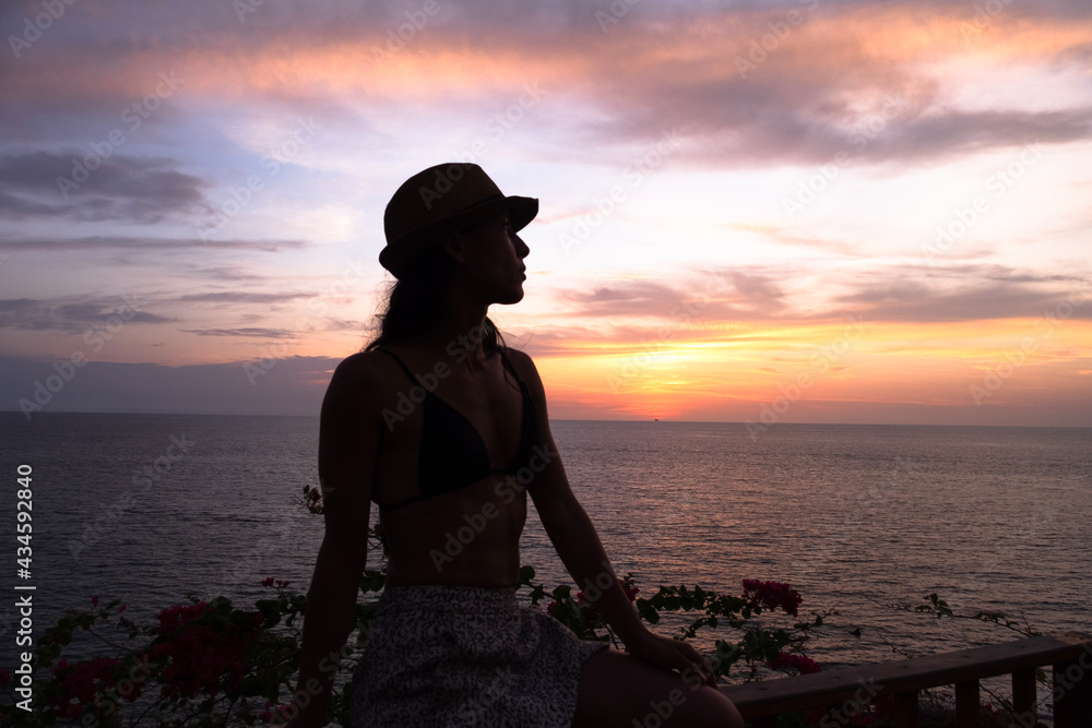 silhouette of a person, with sunset in the background
