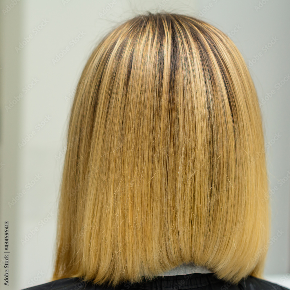 Female hairdresser holds in hand between fingers blond hair, comb and scissors close up, straightening hair tips. Female hairdresser holds in hand between fingers blond hair, comb and scissors close up, straightening hair tips.