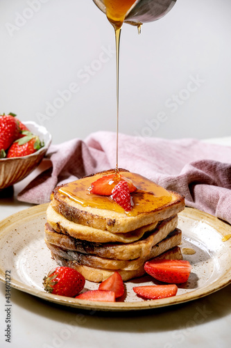 Stockpile of french toasts with fresh strawberries