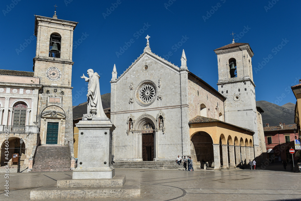 Italy Norcia 06.06.2015 Piazza san Benedetto with the statue of the saint and the basilica before the earthquake of 2016