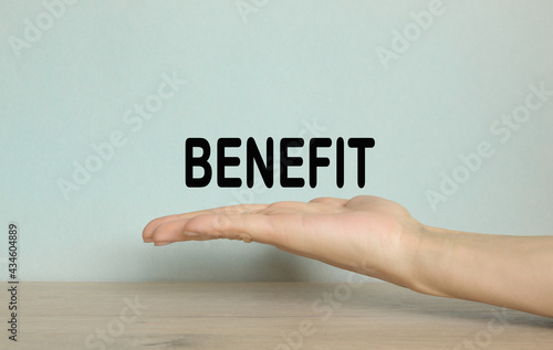 benefit. hand on a blue background. Business, financial, marketing concept.