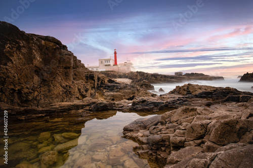 Amazing lighthouse in the Portuguese coastline at the sunset. Cascais Portugal