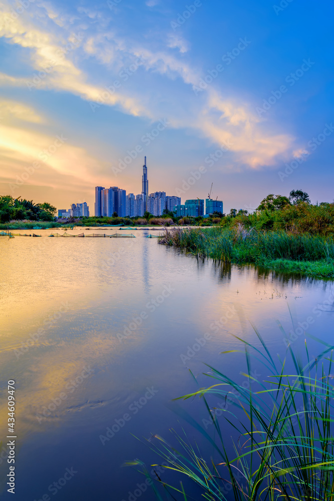 Naklejka premium Sunset on a flooded field in Hochiminh City, Vietnam.