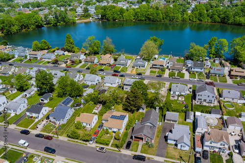 Wide panorama, aerial view with tall single home, in the beautiful residential quarters Sayreville town near pond New Jersey US