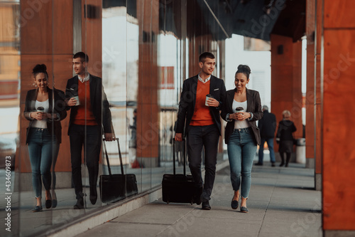 Business man and business woman talking and holding luggage traveling on a business trip